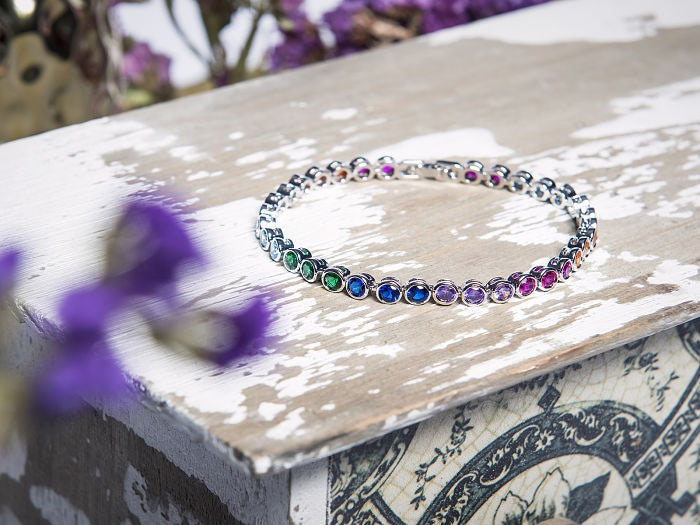 PULSO CON BROCHE Y ZIRCONIAS BISELADAS REDODANAS EN COLORES EN PLATA .925 CON BAÑO DE RODIO